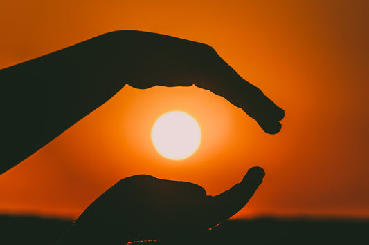 Hands embracing the sun