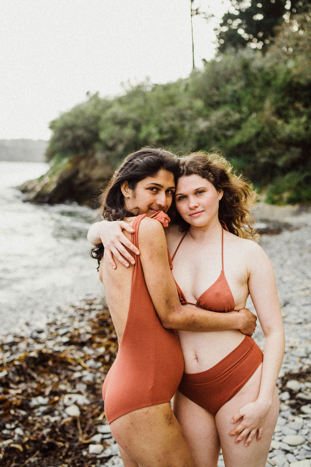 Solpardus models embracing wearing Thea bamboo on Mawnan Smith beach Cornwall. Thea bamboo onepiece Thea bamboo bikini top Thea bamboo bikini bottoms. All natural ethical sustainable bamboo sunwear swimwear perfect for sensitive skin psoriasis and eczema